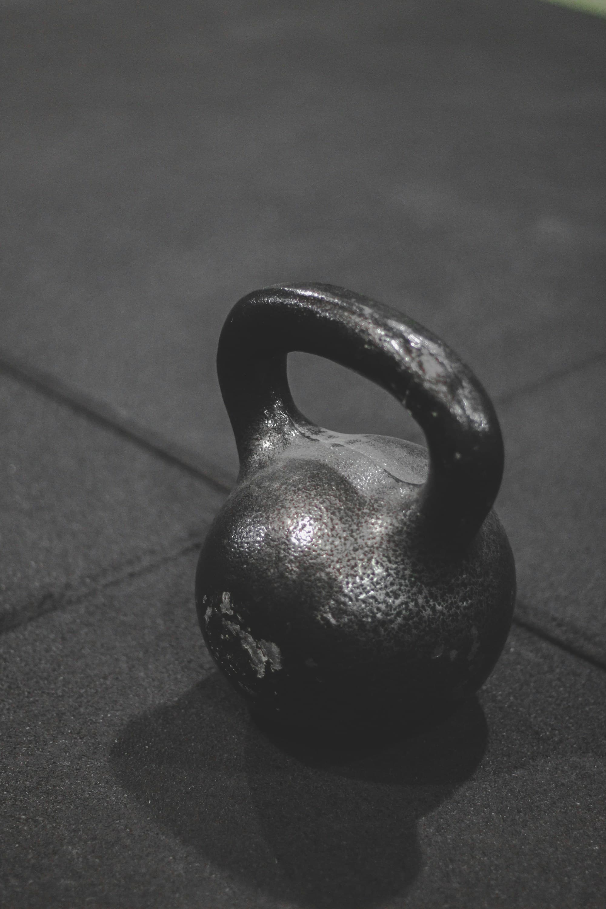 Cast-iron kettlebell on a dark rubber floor